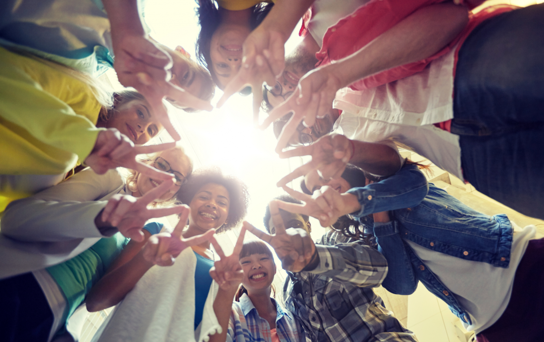 students standing in a ring and showing the peace sign to the camera