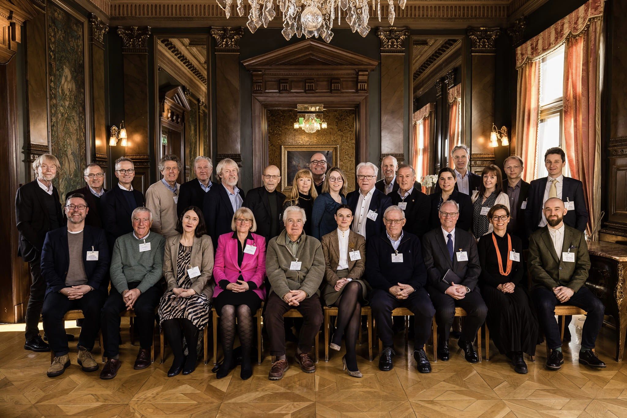 The attendants sitting next to each other in a nice room.