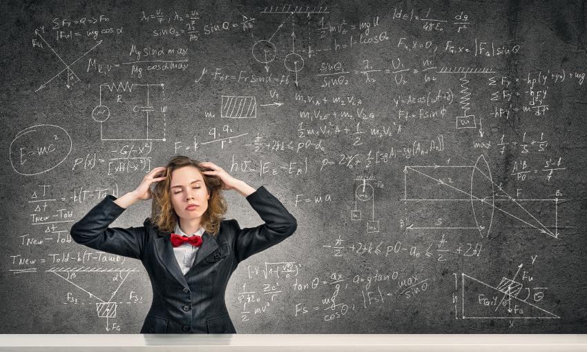 Young woman with disheveled hair against blackboard background