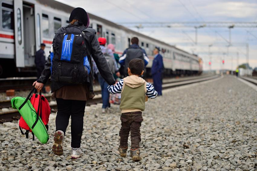 mother and child walking towards train 