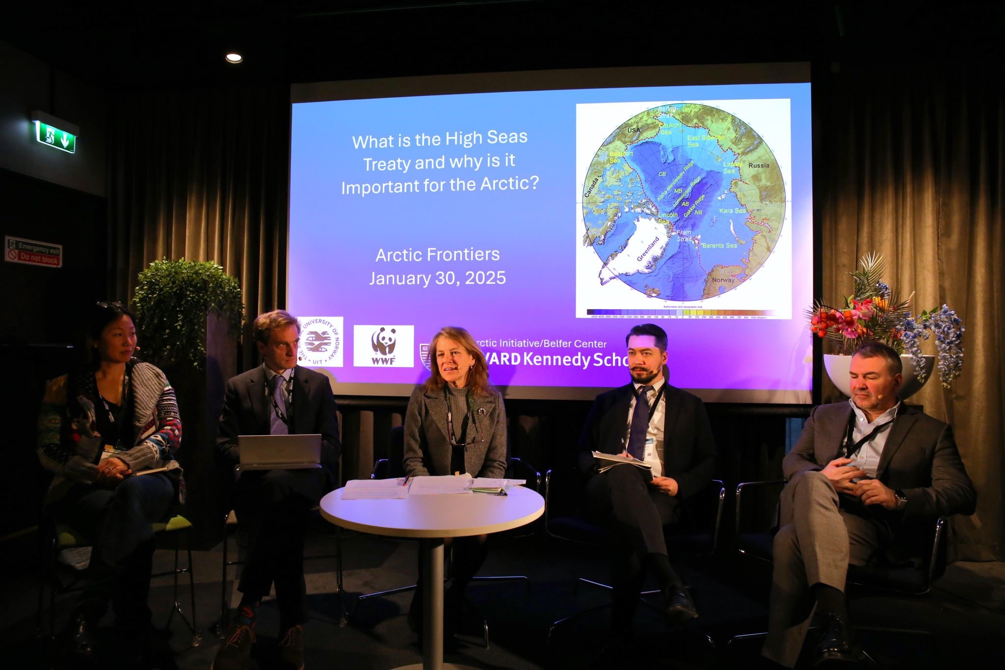 Selection of speakers at the Arctic frontiers 2025 sitting in front of a screen