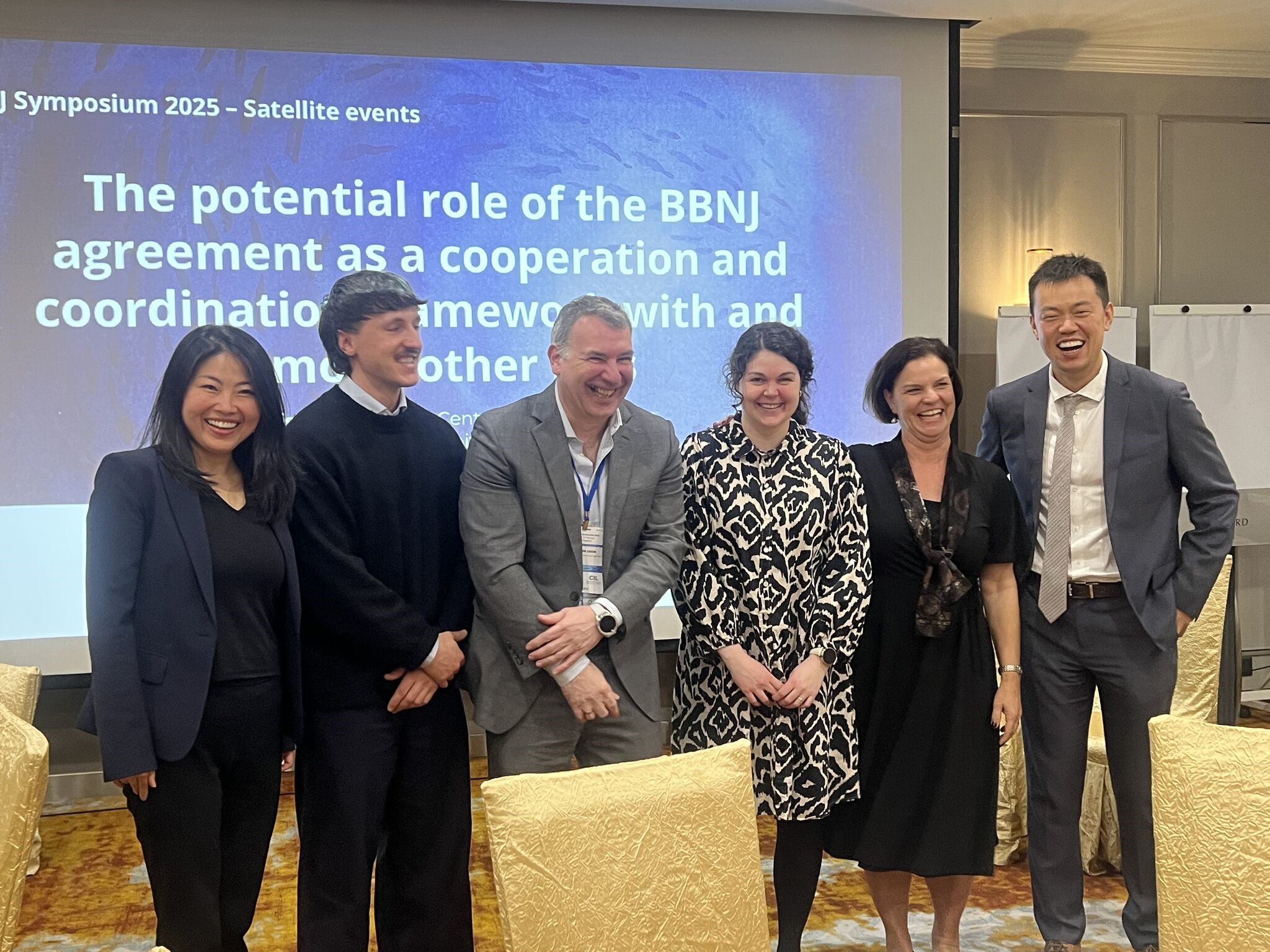 Participants of the BBNJ symposium laughing together in front of the camera