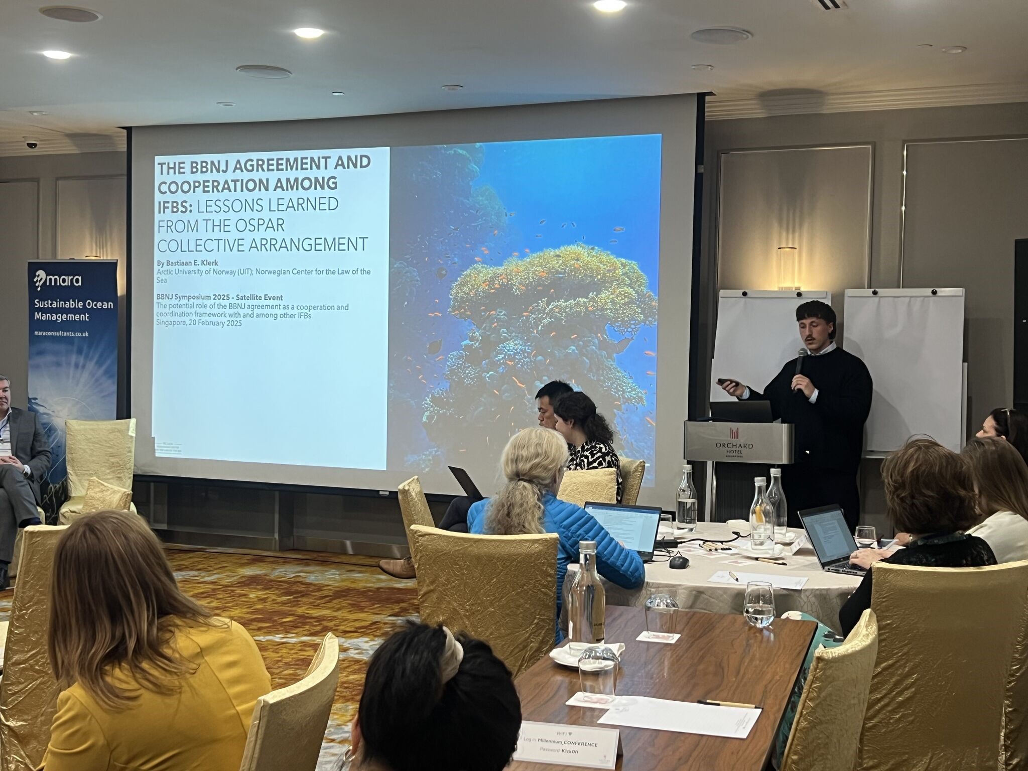 Bastiaan speaking in front of an audience at the symposium