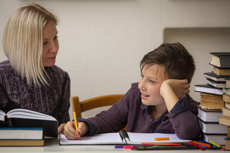 mp56376035-high-school-student-studies-at-home-with-a-female-tutor.jpg