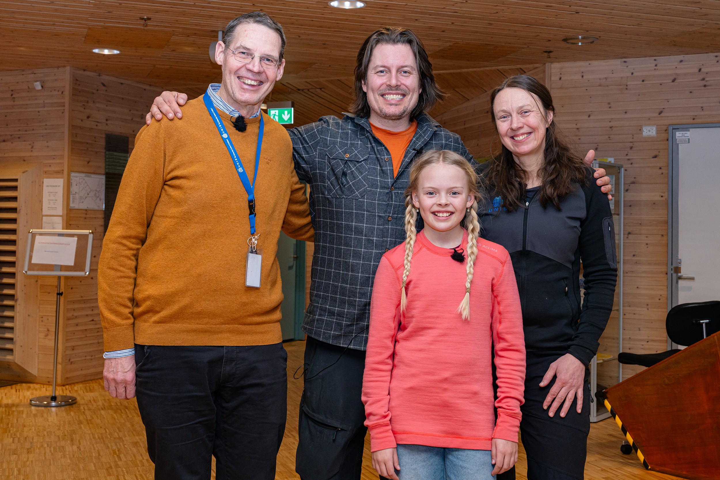 tre voksne og et barn med lange fletter